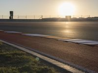 Sunlit Sea Line: Asphalt Road Bathed in Sunlight