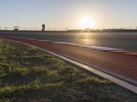 Sunlit Sea Line: Asphalt Road Bathed in Sunlight