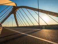 sun shining over an urban bridge in the afternoon as seen from an intersection in california