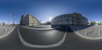 a 360 - view of the city intersection on a sunny day with buildings in the background