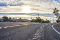 the sun sets on an empty highway on the road to the beach area from a hotel