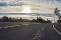 the sun sets on an empty highway on the road to the beach area from a hotel