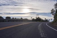 the sun sets on an empty highway on the road to the beach area from a hotel