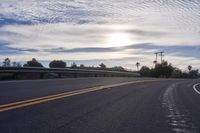 the sun sets on an empty highway on the road to the beach area from a hotel