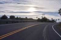 the sun sets on an empty highway on the road to the beach area from a hotel