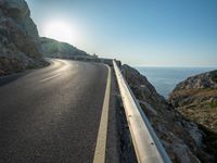 a road leading to a rocky outcropping with some trees in the distance