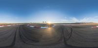 a 360 - view photo of the ring for racing in a drag course near palm trees