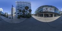 a 360 - view photo of a view from a street corner of several buildings and one is large