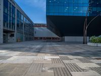 a white building next to a pool in a courtyard area with a walkway leading into it