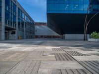 a white building next to a pool in a courtyard area with a walkway leading into it