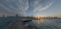 the sunset is about to light up over the city skyline of chicago, illinois from a pier that overlooks lake michigan