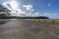 this is the road leading to the beach from the pier in the distance, the sun shines bright over the shore