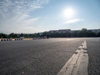 a man riding a skateboard down an empty parking lot in front of a building