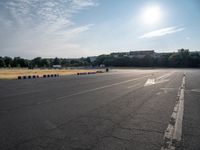 a man riding a skateboard down an empty parking lot in front of a building