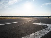 a view of a runway on an airfield with two white arrows pointing right and left