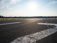 a view of a runway on an airfield with two white arrows pointing right and left