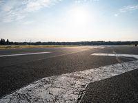 a view of a runway on an airfield with two white arrows pointing right and left