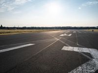 a view of a runway on an airfield with two white arrows pointing right and left