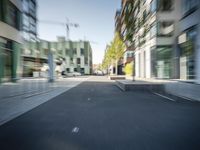 a blurry image of an empty city street on a sunny day in summertime