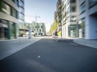 a blurry image of an empty city street on a sunny day in summertime