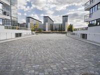 there is an empty courtyard on a sunny day with cloudy skies in the background in this area