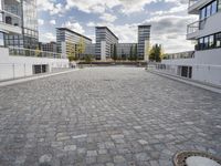 there is an empty courtyard on a sunny day with cloudy skies in the background in this area