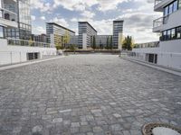 there is an empty courtyard on a sunny day with cloudy skies in the background in this area