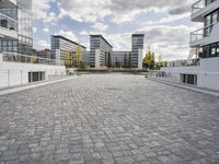 there is an empty courtyard on a sunny day with cloudy skies in the background in this area