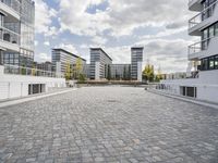 there is an empty courtyard on a sunny day with cloudy skies in the background in this area