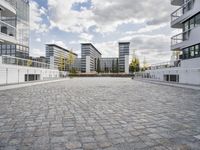 there is an empty courtyard on a sunny day with cloudy skies in the background in this area