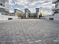 there is an empty courtyard on a sunny day with cloudy skies in the background in this area