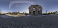 an empty street with a church and people walking on it is shown in this distorted image