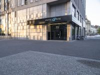 a hotel entrance with the hotel one in the middle of the street on a sunny day