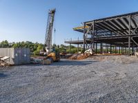 a picture of a building being built on a field near a forest in the background