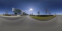 an image of some kind of town at the edge of a street with a big building in the background