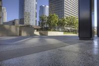 the floor is tiled and has two trees in front of it, and a building with tall windows on one side