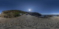 a fisheye image of a beach scene on a sunny day with sun and blue skies