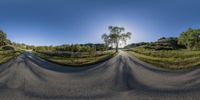 a fish eye view of a country road in a sunny day with no clouds or sunlight