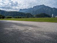 a view of an intersection with mountains in the background on a sunny day in europe