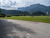 a view of an intersection with mountains in the background on a sunny day in europe