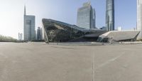 an area with cement, concrete and many very large buildings and lots of grey color