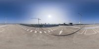 the view from the road on a sunny day through a fish eye lens of the sky and the city skyline