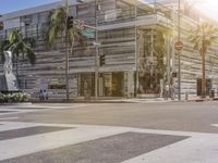 the cross walk leads to an outdoor shopping mall building on a sunny day in hollywood