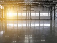 the sun shines brightly through the warehouse windows as they wait for their turn on to go