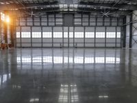 the sun shines brightly through the warehouse windows as they wait for their turn on to go