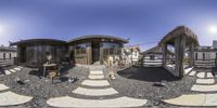 a 360 - view of a person sitting outside a structure of homes with awnings