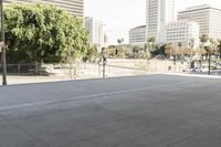 a woman is skateboarding in an outdoor courtyard area near buildings and trees, there are also people around