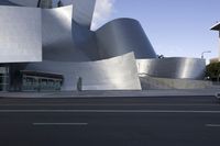 the building in front is made from aluminium sheet with a curved top and side wall