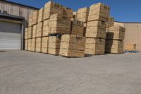 a number of stacks of hay stacked next to each other in a warehouse with a sky background