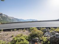 a motorcycle is parked on a scenic road near the mountains in france's south